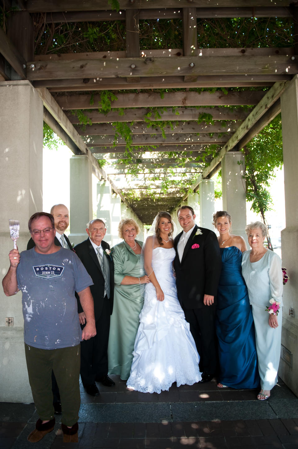 Dad takes a moment from painting to smile for the family photo.