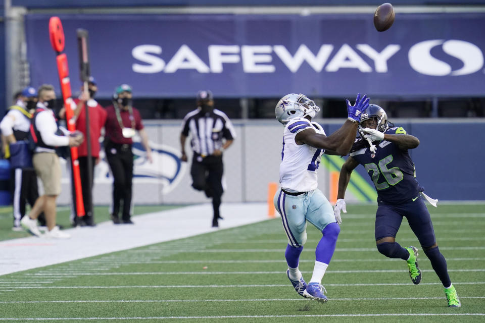 Dallas Cowboys wide receiver Michael Gallup makes a catch as Seattle Seahawks cornerback Shaquill Griffin (26) defends during the second half of an NFL football game, Sunday, Sept. 27, 2020, in Seattle. (AP Photo/Elaine Thompson)