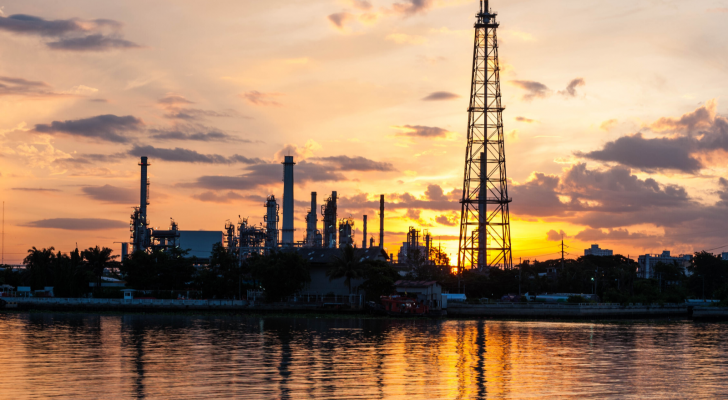 INDO stock: petrochemical plant in night time with reflection over the river, Indonesia.