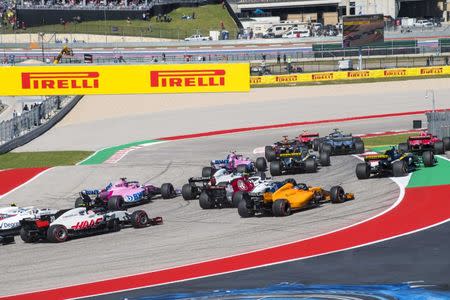Oct 21, 2018; Austin, TX, USA; The field of drivers drive through turn one at the start of the United States Grand Prix at Circuit of the Americas. Mandatory Credit: Jerome Miron-USA TODAY Sports