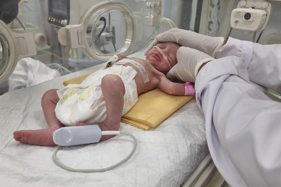 A Palestinian baby girl, Sabreen Jouda, who was delivered prematurely after her mother was killed in an Israeli strike along with her husband and daughter, lies in an incubator in the Emirati hospital in Rafah, southern Gaza Strip. Sunday, April 21, 2024. (AP Photo/Mohammad Jahjouh)