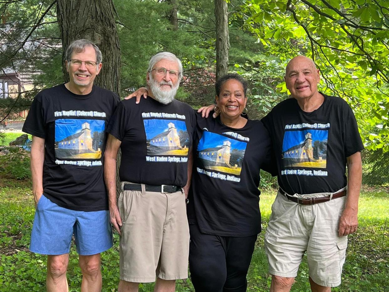 David Gudaitis, Alan Backler, Elizabeth Mitchell and Larry Laswell stand together wearing T-shirts promoting their 2023 film, "A Labor of Love."