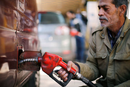 A man fills the tank of a car at a petrol station in Damascus, Syria , February 19, 2017. Picture taken February 19, 2017. REUTERS/Omar Sanadiki