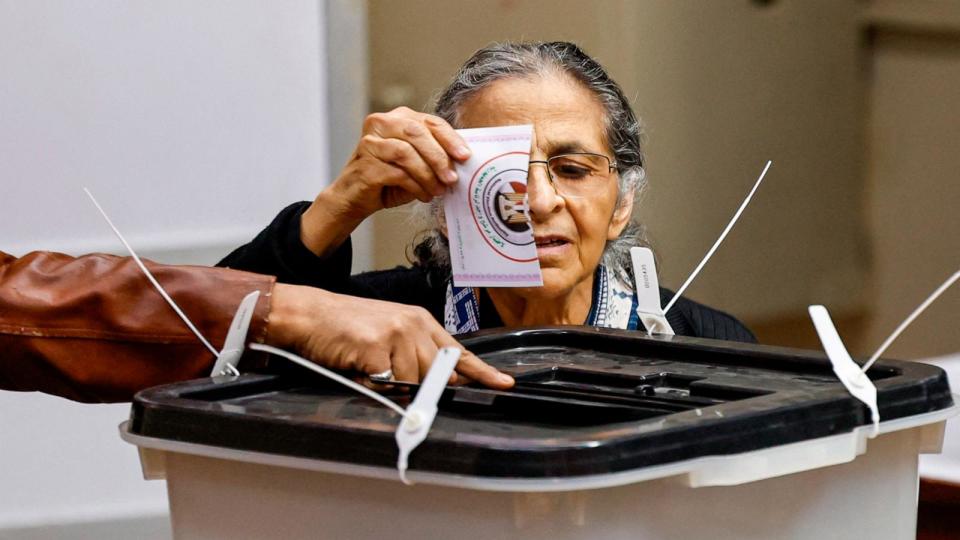 PHOTO: A woman casts her vote at a polling station in the Zamalek district of Egypt's capital Cairo during the presidential elections on Dec. 11, 2023. (Khaled Desouki/AFP via Getty Images)