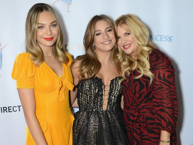 <p>Albert L. Ortega/Getty</p> Maddie Ziegler and Mackenzie Ziegler with their mother arrive for the LA Premiere Of "Ice Princess Lily" on November 16, 2019 in Santa Monica, California.