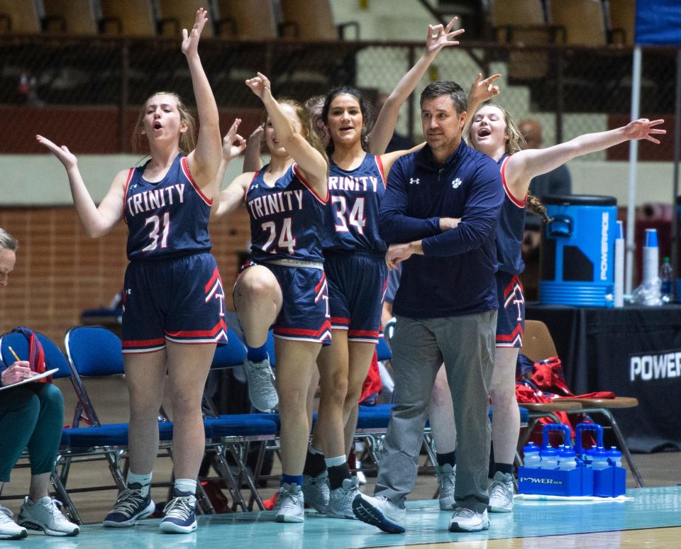 Trinity's bench celebrates a three-pointer as Trinity Presbyterian faces off with Houston Academy during the class 3A regional semi-final at Garrett Coliseum in Montgomery, Ala., on Thursday, Feb. 17, 2022.