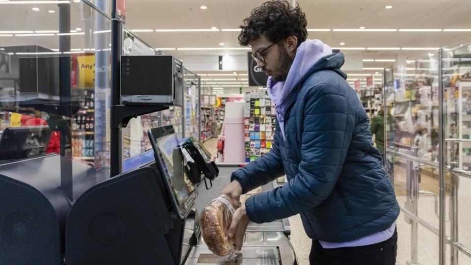 Man using self-service till supermarket in North East of England