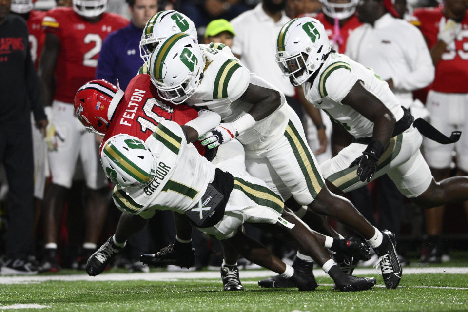 Maryland wide receiver Tai Felton (10) is tackled by Charlotte defensive back Dontae Balfour (1) and others during the first half of an NCAA college football game, Saturday, Sept. 9, 2023, in College Park, Md. (AP Photo/Nick Wass)