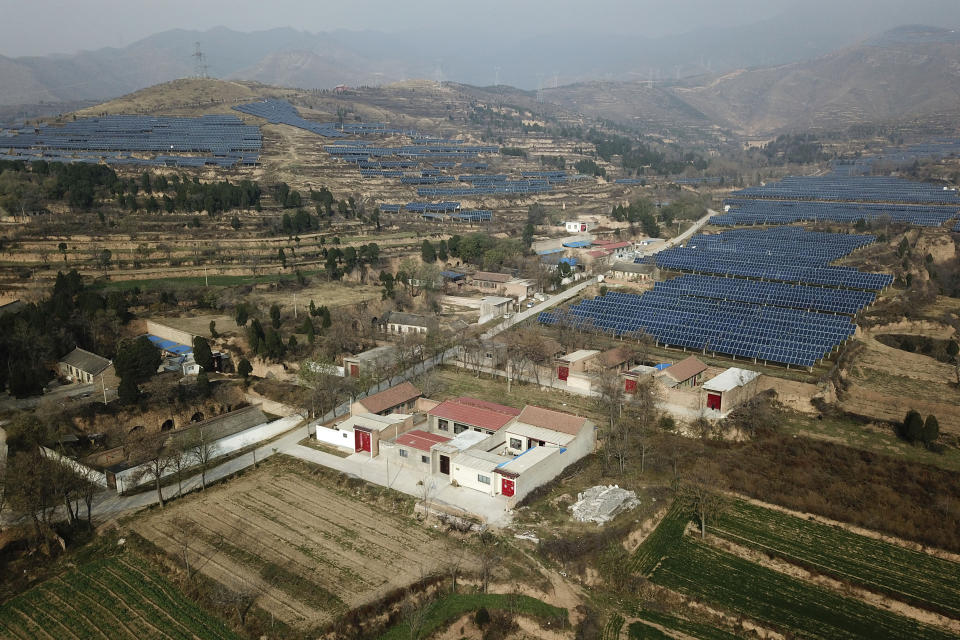 In this Nov. 28, 2019, photo, a solar panel installation is seen in Ruicheng County in central China's Shanxi Province. As world leaders gather in Madrid to discuss how to slow the warming of the planet, a spotlight is falling on China, the top emitter of greenhouse gases. China burns about half the coal used globally each year. Yet it's also the leading market for solar panels, wind turbines and electric vehicles. (AP Photo/Sam McNeil)