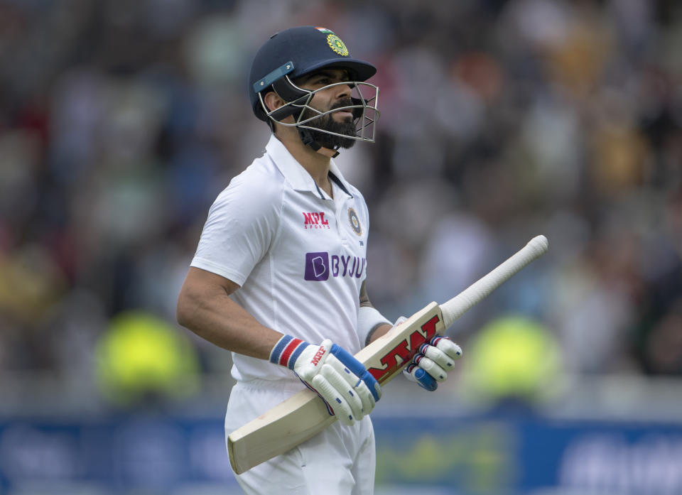 Virat Kohli (pictured) walks back to the pavilion after being dismissed.