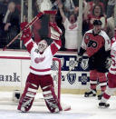 FILE - Detroit Red Wings goalie Mike Vernon, left, celebrates after winning the Stanley Cup as Philadelphia Flyers John LeClair, right, looks away Saturday, June 7, 1997, in Detroit. Detroit beat the Flyers 2-1 to sweep Philadelphia in four games. Vernon is one of five players elected to the Hockey Hall of Fame, Wednesday, June 21, 2023. (AP Photo/Carlos Osorio, File)
