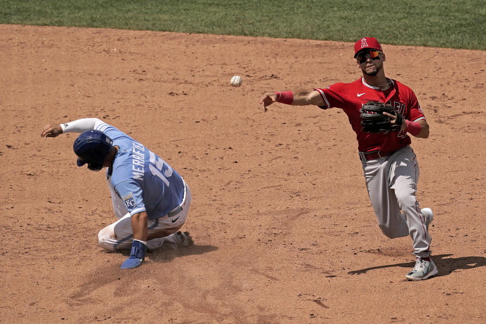 Los Angeles Angels shortstop Andrew Velazquez throws to first after forcing Kansas City Royals' Whit Merrifield (15) out at second on a force out hit into by Andrew Benintendi during the the seventh inning of a baseball game Wednesday, July 27, 2022, in Kansas City, Mo. (AP Photo/Charlie Riedel)