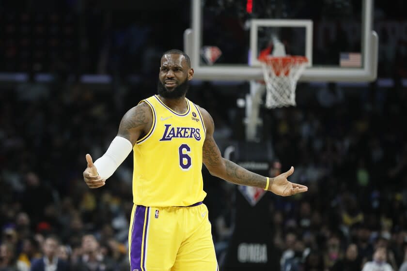 Lakers forward LeBron James raises his arms and scrunches his face in dissatisfaction with a ref's call