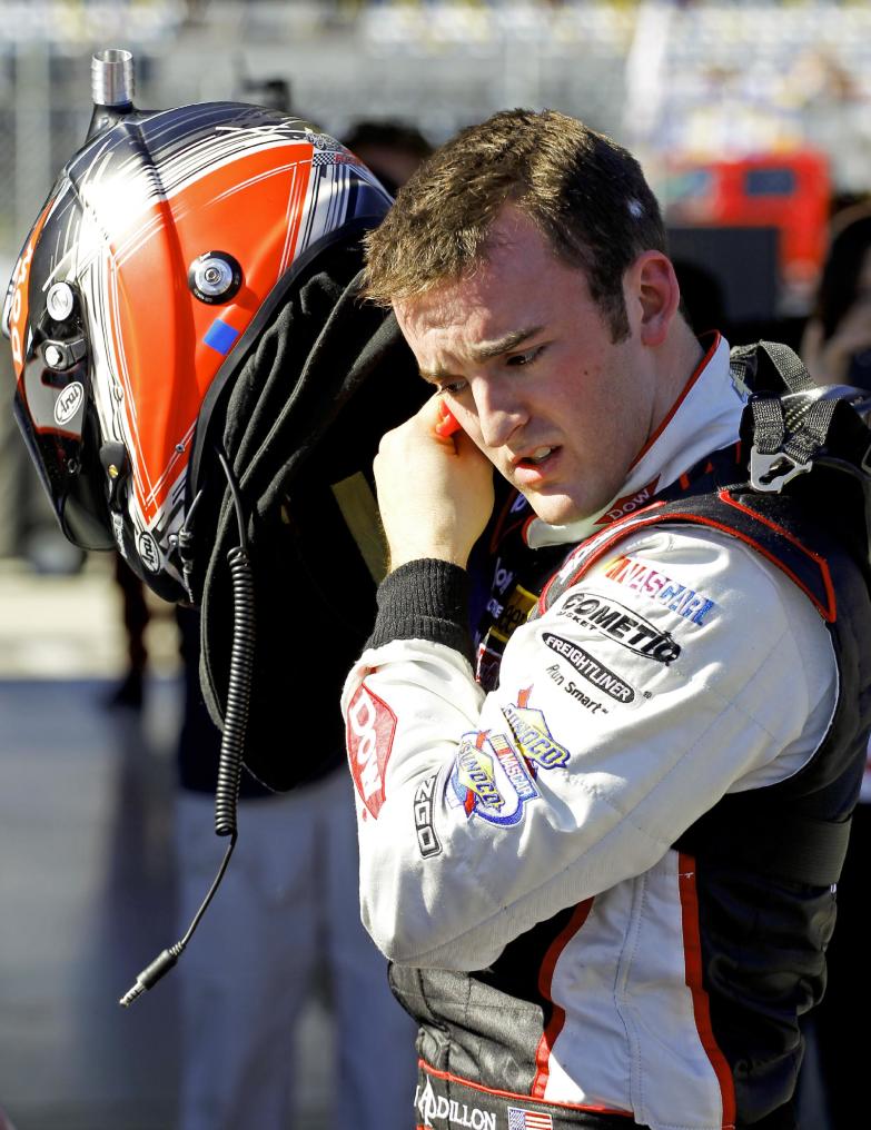 CORRECTS NAME TO DILLON NOT DILLION Austin Dillon removes his helmet after his qualifying run for the Daytona 500 NASCAR Sprint Cup Series auto race at Daytona International Speedway in Daytona Beach, Fla., Sunday, Feb. 16, 2014. Dillon won the pole position for the race. (AP Photo/Terry Renna)