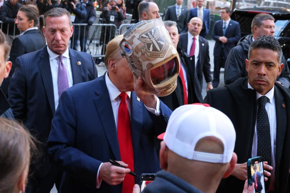 Trump holds up a welder mask during the visit. Getty Images