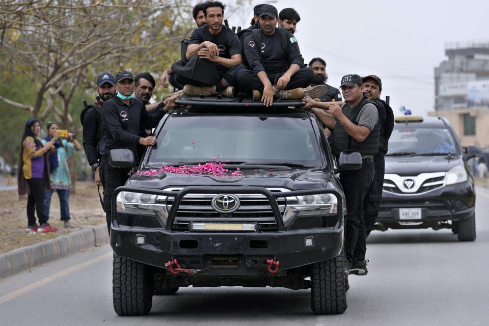 Security personnels secure a vehicle carrying the Pakistan's former Prime Minister Imran Khan arrives to appear in a court, in Islamabad, Pakistan, Tuesday, May 23, 2023. Khan on Tuesday pressed his legal battle before a court in the capital, Islamabad, which granted him protection from arrest until early next month in several cases where he faces terrorism charges for inciting violence. (AP Photo/Anjum Naveed)