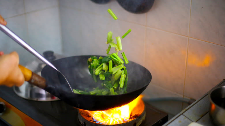 Tossing food in a wok
