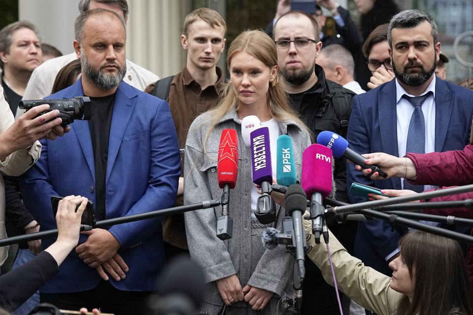 Miroslava Reginskaya, wife of Igor Girkin also know as Igor Strelkov, the former military chief for Russia-backed separatists in eastern Ukraine, center, speaks to the media, flanked by Pavei Gubarev, self-proclaimed "People's Governor" of the Donetsk Region, left, and Igor Girkin's lawyer Haji Aliye, right, at the Moscow's City Court in Moscow, Russia, on Tuesday, Aug. 29, 2023. A Moscow court has ruled that a prominent hard-line nationalist who accused Russian President Vladimir Putin of weakness and indecision in Ukraine will remain in prison until Sept. 18 on charges of extremism. (AP Photo/Alexander Zemlianichenko)