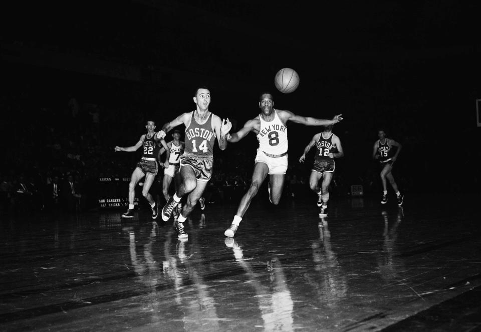 New York’s Nat Clifton (8) and Boston’s Bob Cousy (14) race for a loose ball in the opening period of a professional basketball game at Madison square garden, New York, on Nov. 12, 1955. Following the chase, background, are Boston’s Ed Macauley (22) and Togo Palazzi (12), and New York’s Gene Shue. (AP Photo/TF)