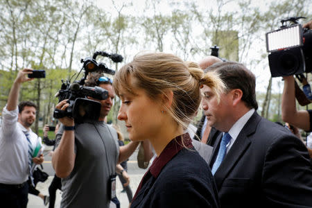 Actor Allison Mack, known for her role in the TV series 'Smallville', exits with her lawyer following a hearing on charges of sex trafficking in relation to the Albany-based organization Nxivm at United States Federal Courthouse in Brooklyn, New York, U.S., May 4, 2018. REUTERS/Brendan McDermid