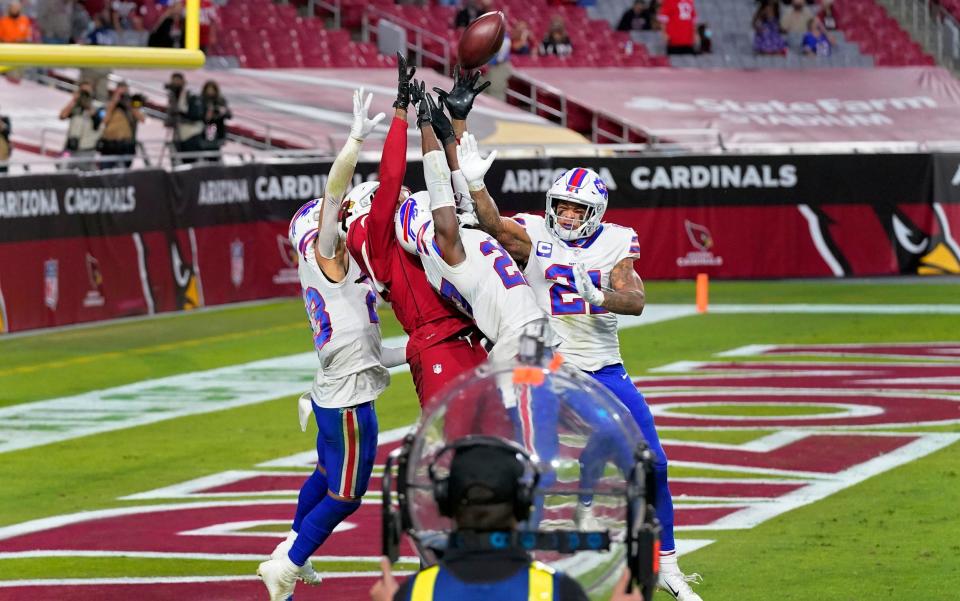 Arizona Cardinals wide receiver DeAndre Hopkins (10) catches the game-winning touchdown as Buffalo Bills cornerback Tre'Davious White, right, free safety Jordan Poyer (21) and strong safety Micah Hyde, left, defend during the second half of an NFL football game, Sunday, Nov. 15, 2020, in Glendale, Ariz.  - AP