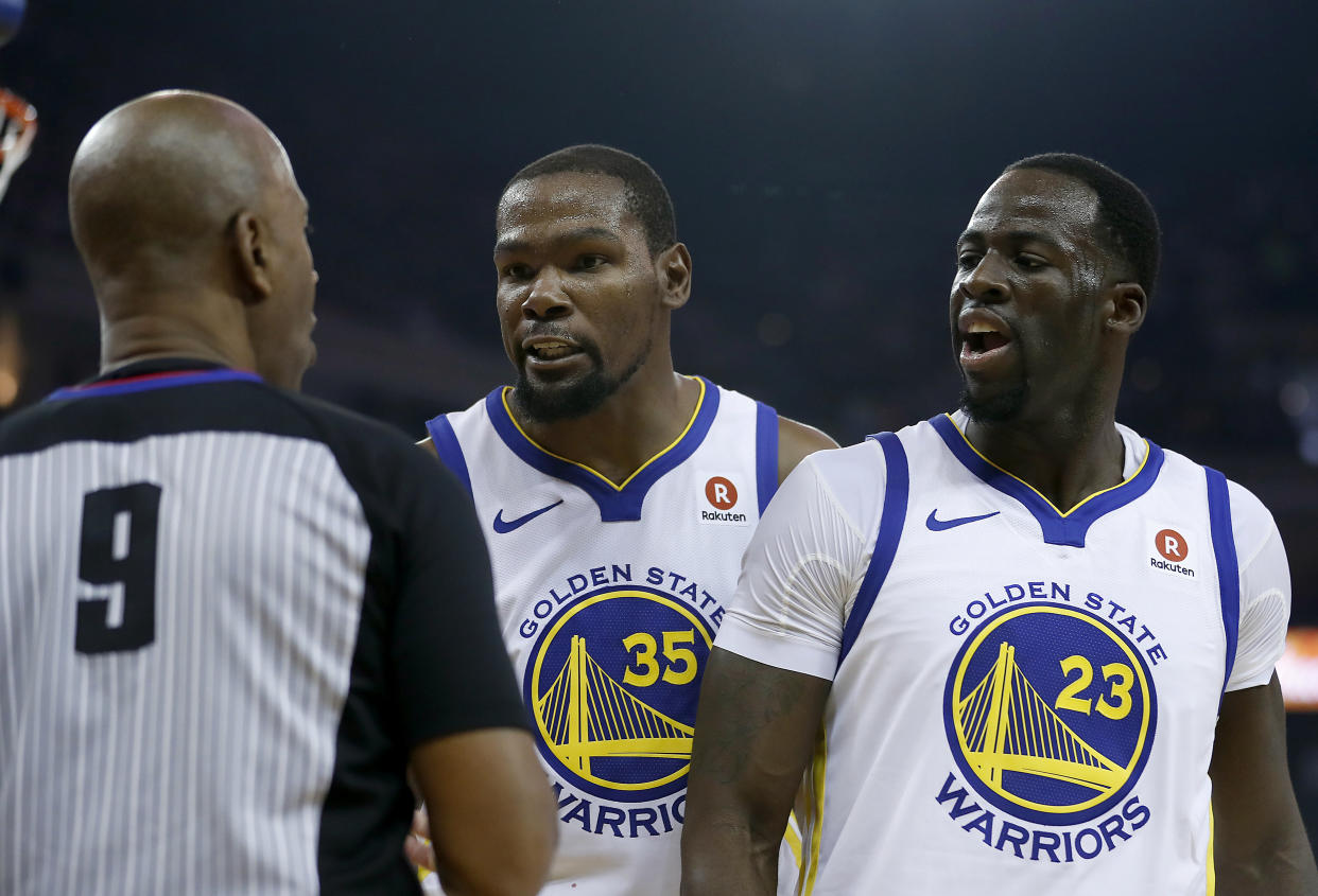 Golden State Warriors forwards Kevin Durant and Draymond Green argue a call with referee Derrick Stafford during the first half against the Cleveland Cavaliers, Monday, Dec. 25, 2017. (AP Photo/Tony Avelar)