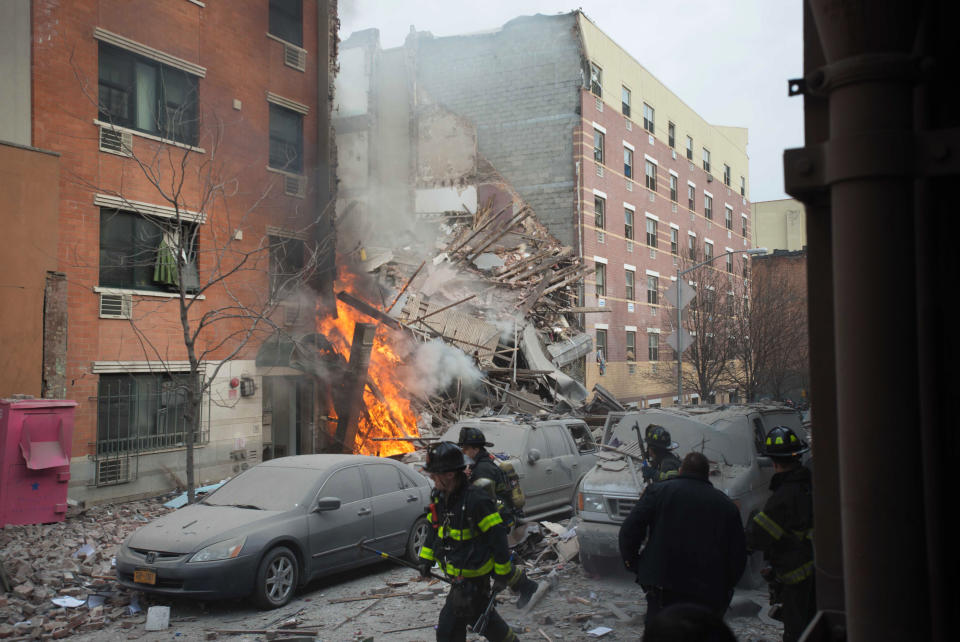 Firefighters work the scene of an explosion that leveled two apartment buildings in the East Harlem neighborhood of New York, Wednesday, March 12, 2014. Con Edison spokesman Bob McGee says a resident from a building adjacent to the two that collapsed reported that he smelled gas inside his apartment, but thought the odor could be coming from outside. (AP Photo/Jeremy Sailing)