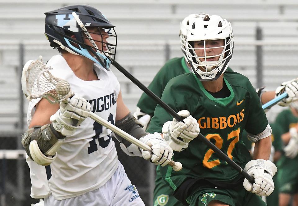 Hoggard's Aidan Flynn (left) passes the ball during the Vikings' state quarterfinal game vs. Cardinal Gibbons on Thursday. KEN BLEVINS/STARNEWS