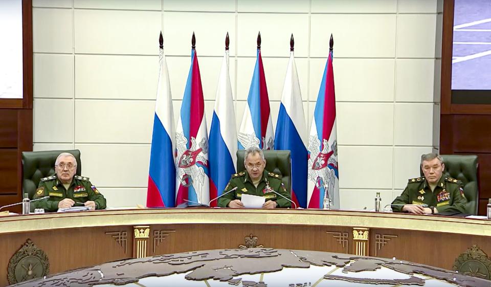 In this photo taken from video released by Russian Defense Ministry Press Service, Russian Defense Minister Sergei Shoigu speaks during a meeting in the Russian Defense Ministry office in Moscow, Russia, Wednesday, Sept. 21, 2022. General Staff chief, Gen. Valery Gerasimov, right, and Deputy Defense Minister Ruslan Tsalikov, left, attend the meeting. Russian President Vladimir Putin has announced a partial mobilization in Russia as the fighting reaches nearly seven months. Shoigu said in a televised interview Wednesday, Sept. 21, 2022 that conscripts and students won't be mobilized only those with relevant combat and service experience will be. (Russian Defense Ministry Press Service via AP)