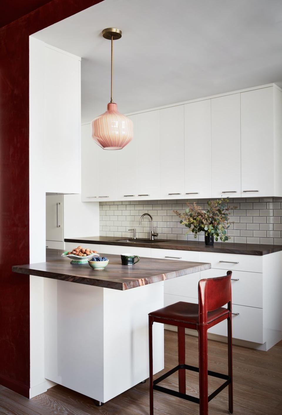 a kitchen with a red chair