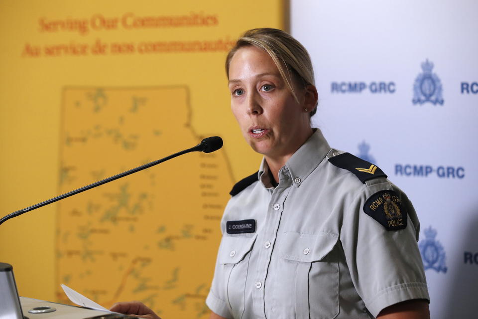 Royal Canadian Mounted Police Cpl. Julie Courchaine speaks to media about the ongoing RCMP search in Gillam, Manitoba, for the British Columbia murder suspects Bryer Schmegelsky, 18, and Kam McLeod, 19, in Winnipeg, Manitoba, Friday, July 26, 2019. Gillam is more than 2,000 miles from northern British Columbia, where the three people were found slain. (John Woods/The Canadian Press via AP)