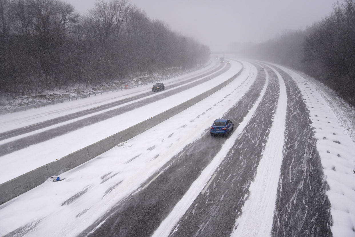 Vehicles travel along Interstate 44 as snow begins to fall and temperatures drop in St. Louis.