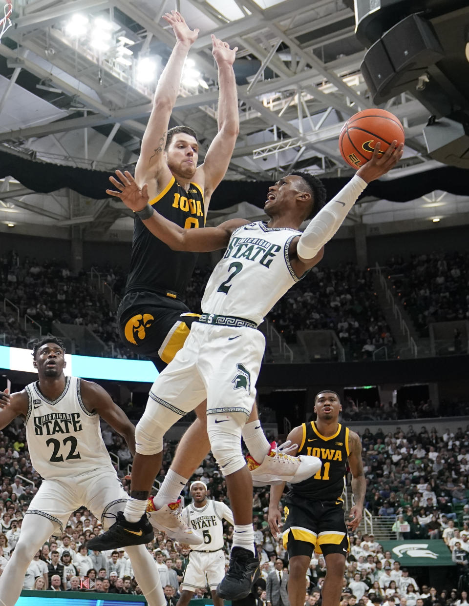 Michigan State guard Tyson Walker (2) attempts a basket as Iowa forward Filip Rebraca defends during the second half of an NCAA college basketball game, Thursday, Jan. 26, 2023, in East Lansing, Mich. (AP Photo/Carlos Osorio)