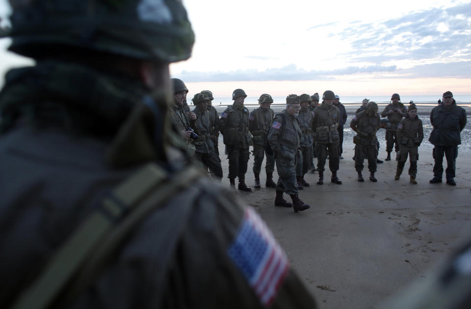 World War II reenactors from Switzerland gather at dawn on Omaha Beach, in Normandy, France, Thursday, June 6, 2019 during commemorations of the 75th anniversary of D-Day. (AP Photo/Thibault Camus)