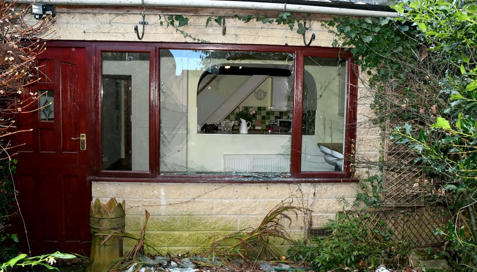 A broken window at the property after Aaron Marsden Booth broke in. (SWNS)