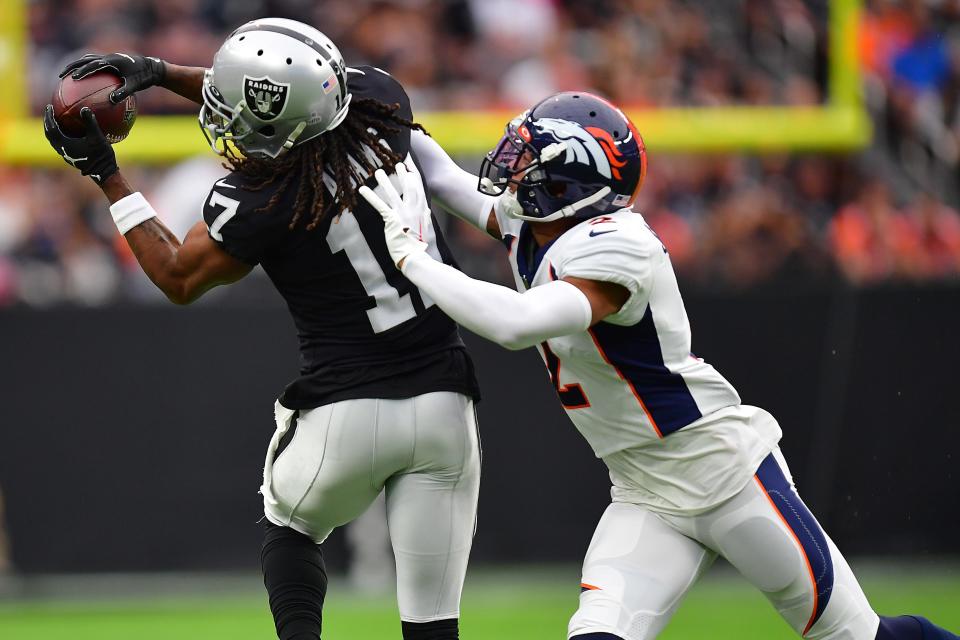 Oct 2, 2022; Paradise, Nevada, USA; Las Vegas Raiders wide receiver Davante Adams (17) catches a pass against Denver Broncos cornerback Pat Surtain II (2) during the first half at Allegiant Stadium. Mandatory Credit: Gary A. Vasquez-USA TODAY Sports