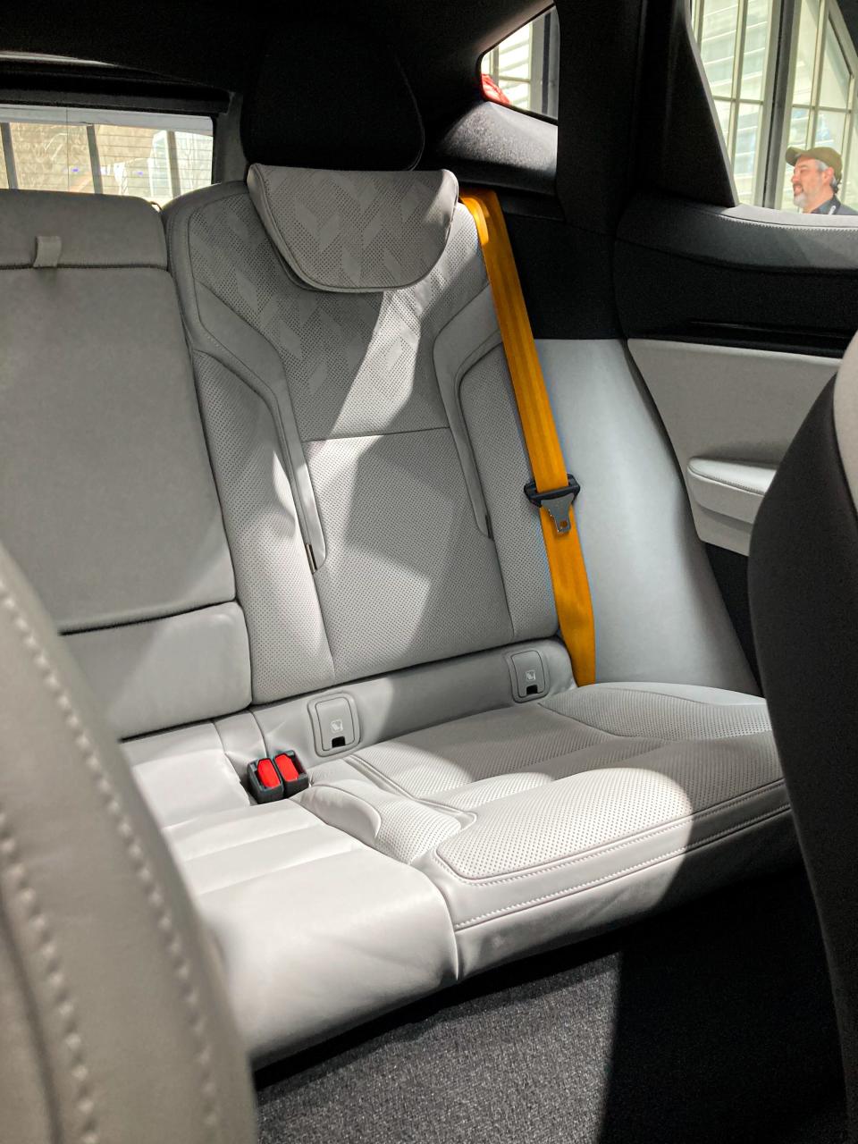 A white rear seat in the Polestar 3 electric SUV, with a yellow seatbelt.