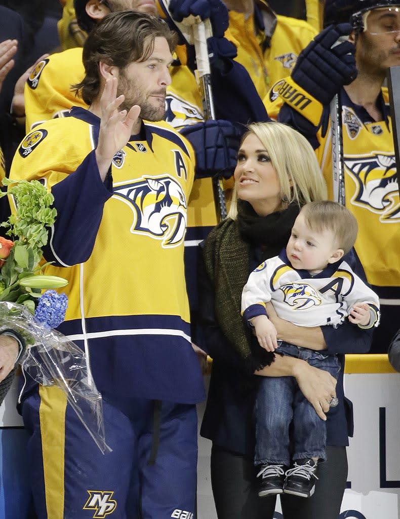 Carrie and Isaiah were on hand last year when Mike Fisher was honored for playing in his 1,000th NHL game. (Mark Humphrey/AP)