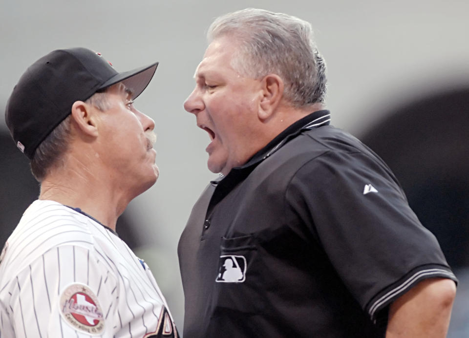 FILE - In this April 21, 2006, file photo, Houston Astros manager Phil Garner, left, gets into it with home plate umpire Rick Reed, right, and is thrown out of a baseball game in the first inning against the Pittsburgh Pirates in Houston. Reed, whose career as a big league umpire spanned three decades and included two All-Star games and a World Series, has died. He was 70. (AP Photo/Tim Johnson, File)