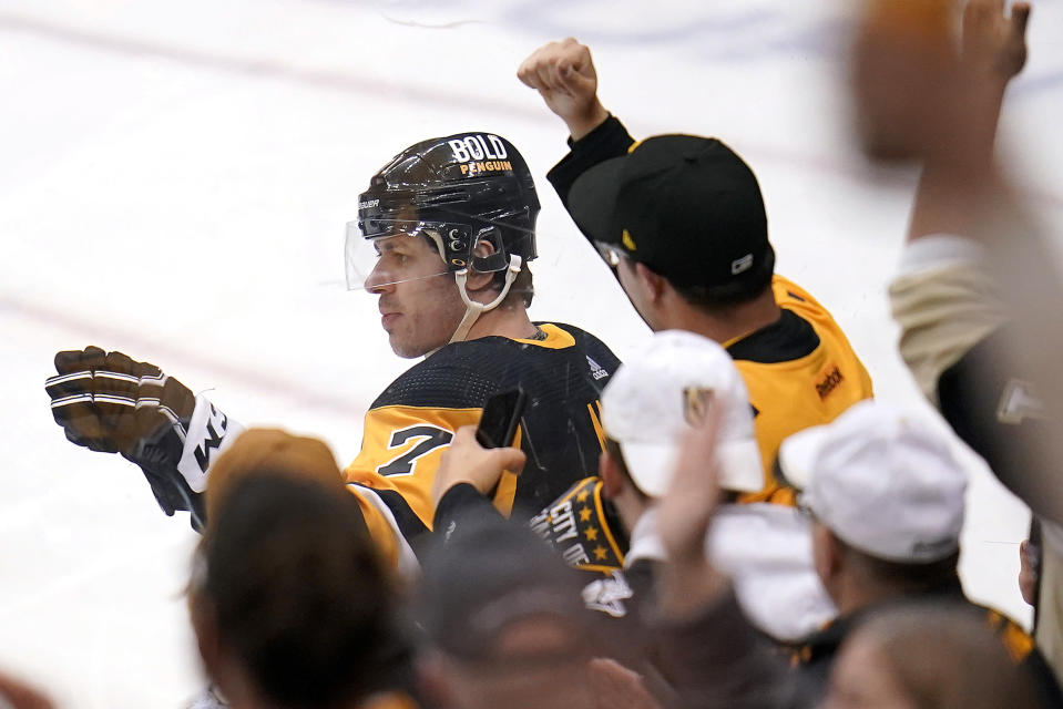 Pittsburgh Penguins' Evgeni Malkin, left, celebrates his goal during the first period of an NHL hockey game against the Columbus Blue Jackets in Pittsburgh, Friday, April 29, 2022. (AP Photo/Gene J. Puskar)