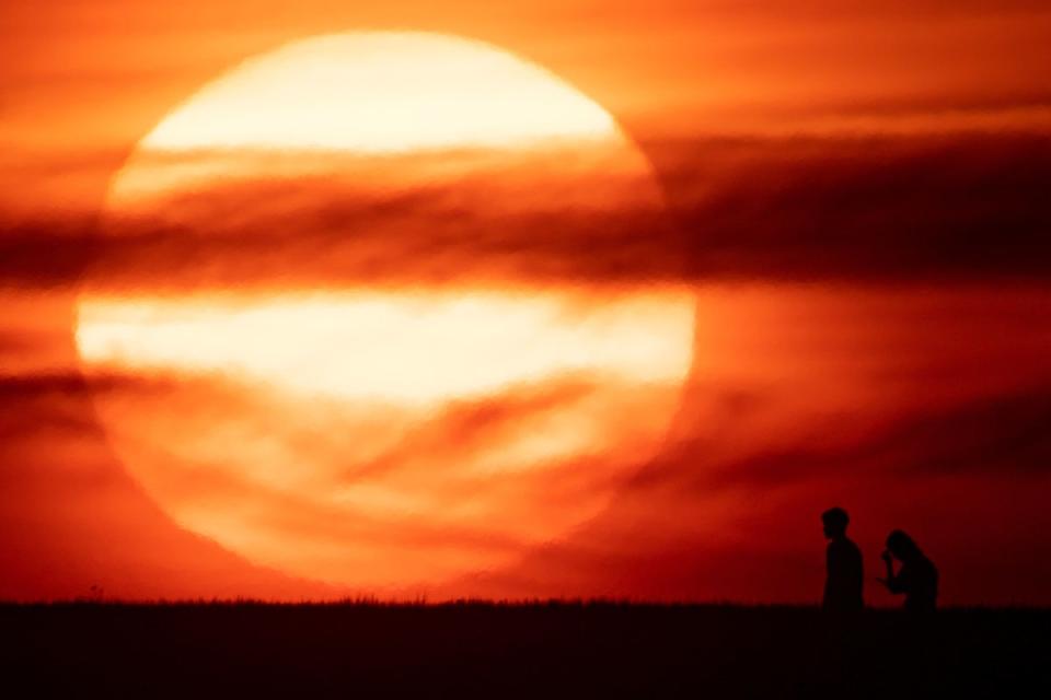 The sun setting in Chesterton, Warwickshire in June 2022, ahead of the first of the year’s heatwaves (PA)
