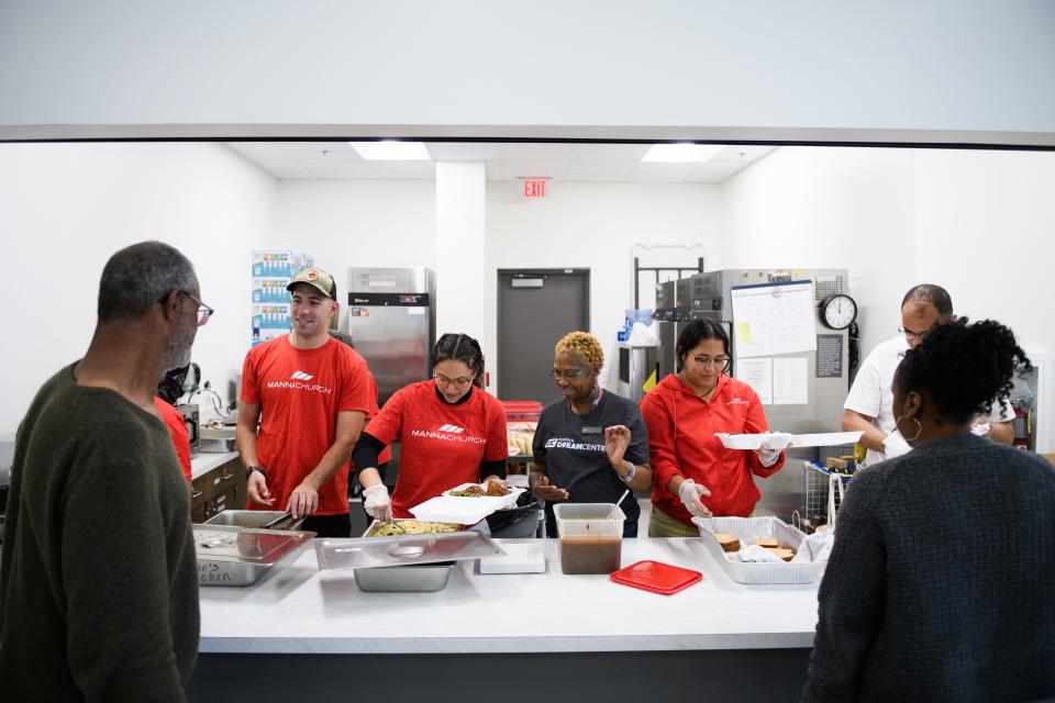 Manna Dream Center members help serve lunch to people in need at the Day Resource Center on Wednesday, May 15, 2024. Manna Dream Center will be the new operator of the Day Resource Center starting July 1.