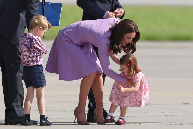 Princess Charlotte is helped up by the Duchess of Cambridge after she fell over during a visit to Germany (Jane Barlow/PA)