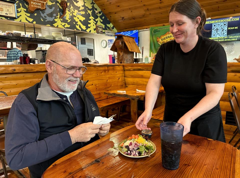 Amy Ruggiero serves a salad to Dennis Dahl of Blue Springs, Missouri, at the Old Mill Eatery & Smokehouse in the city of Shasta Lake. Dahl is an engineer who's in town to work on a rebuild of the nearby Knauf Insulation plant.