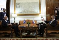 Greek Foreign Minister Nikos Dendias, left, listens his Russian counterpart Sergei Lavrov during their meeting in Athens, Monday, Oct. 26, 2020. The talks of the two diplomats are focus on the situation between Greece and Turkey as the neighbour country announced late Saturday that it is extending by one week a gas exploration mission in the eastern Mediterranean that has caused tensions with Greece. (Costas Baltas/Pool via AP)