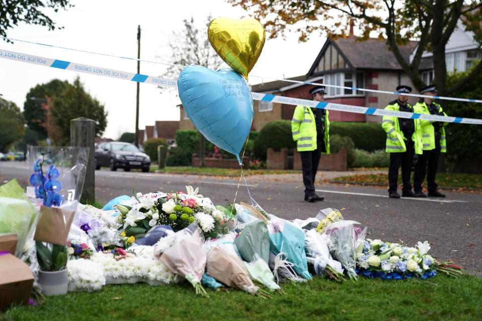 Police officers stand by the scene near Belfairs Methodist Church in Eastwood Road North, where member of Parliament David Amess died after he was stabbed several times on Friday, in Leigh-on-Sea, Essex, England, Sunday, Oct. 17, 2021. The slaying Friday of the 69-year-old Conservative lawmaker Amess during his regular weekly meeting with local voters has caused shock and anxiety across Britain's political spectrum, just five years after Labour Party lawmaker Jo Cox was murdered by a far-right extremist in her small-town constituency. (Kirsty O'Connor/PA via AP)