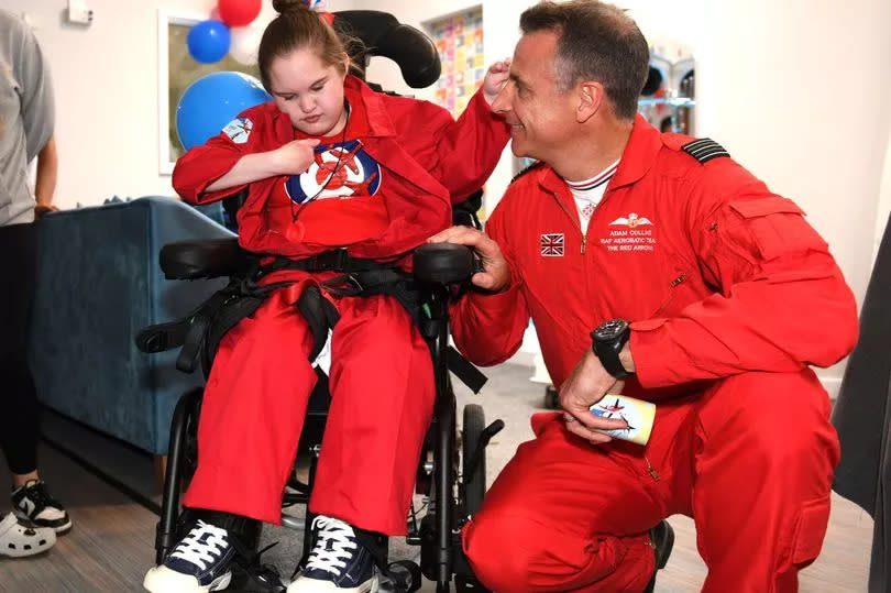 Lily-Mae Hutton, 13 with the Red Arrows RAF Acrobatic Team's Adam Collins during their visit to St Andrew's Hospice where they met children and opened the new Red Arrows room -Credit:Donna Clifford/GrimsbyLive