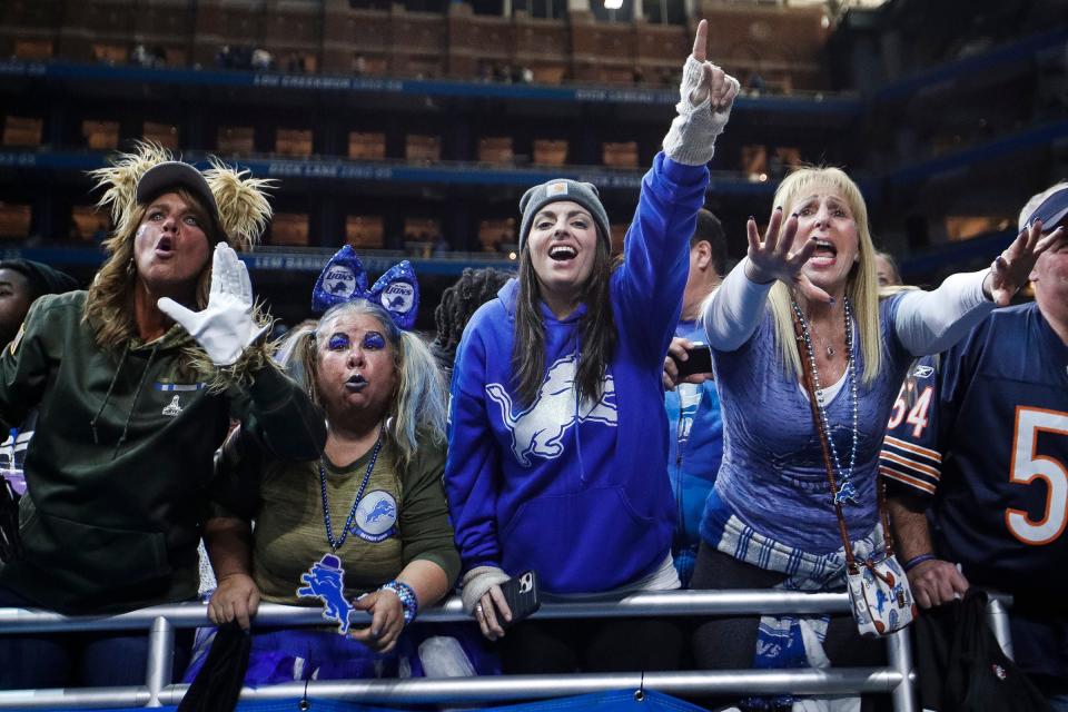 Detroit Lions fans celebrate the 31-26 comeback win over the Chicago Bears at Ford Field in Detroit on Sunday, Nov. 19, 2023.