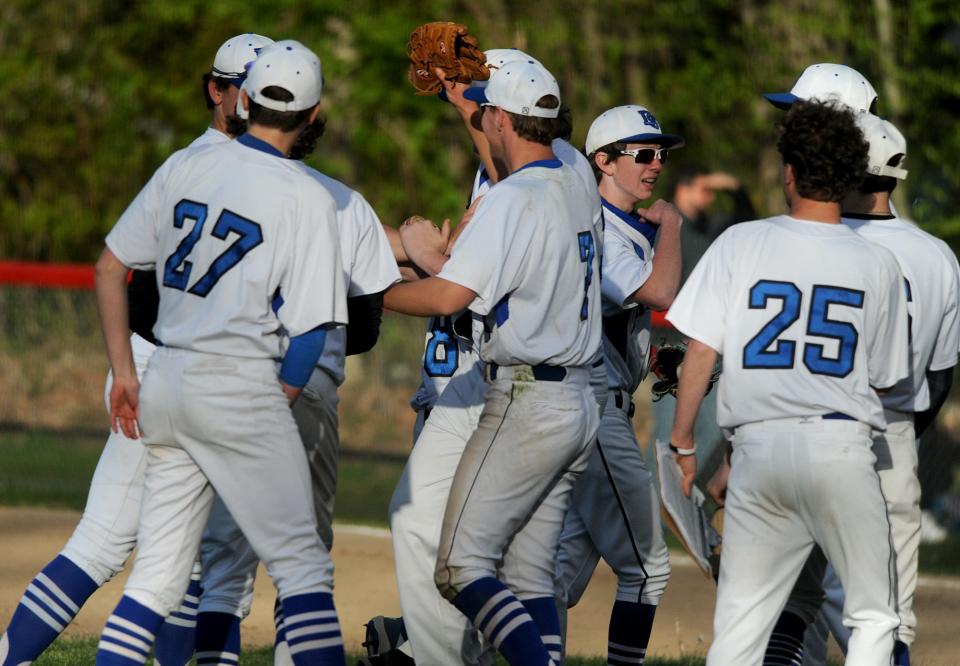 The Dover-Sherborn High School baseball team celebrates its 8-7 victory at Holliston on May 11.