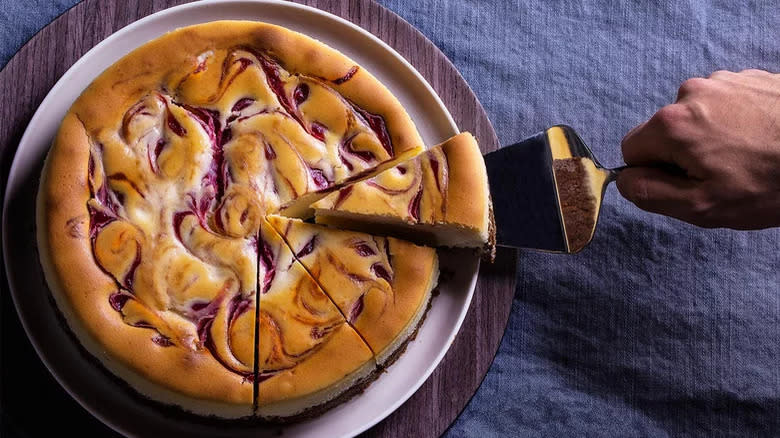 Swirled raspberry cheesecake being served
